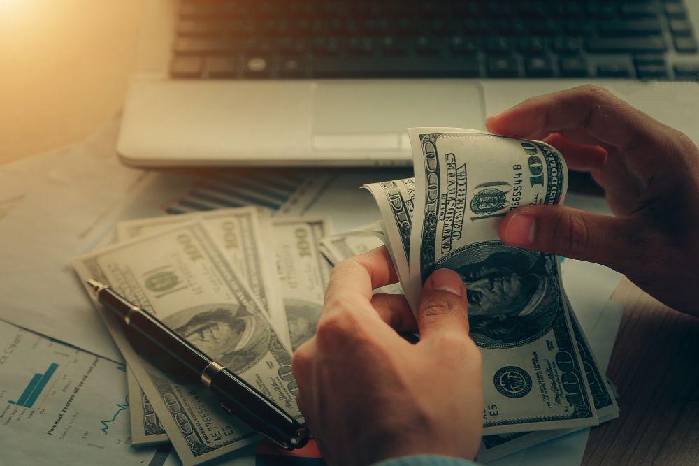 close-up-male-hands-counting-dollar-bills.jpg